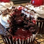 Black Forest Cupcakes with moist chocolate cake, cherry filling, whipped cream, and a whole cherry on top.