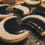 Moon cookies decorated to represent the lunar phases with white icing and black food coloring