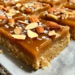 Delicious honey caramel almond shortbread bars displayed on a plate.