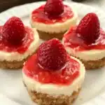 Delicious mini strawberry cheesecakes topped with fresh strawberries