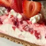 No Bake Strawberry Cheesecake topped with fresh strawberries and whipped cream