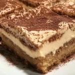 Delicious tiramisu blondies topped with cocoa powder and espresso drizzle.