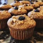 Baked whole wheat muffins on a wooden table with a cozy background