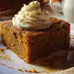 Delicious Maple Gingerbread Cake with a rich spiced cream topping